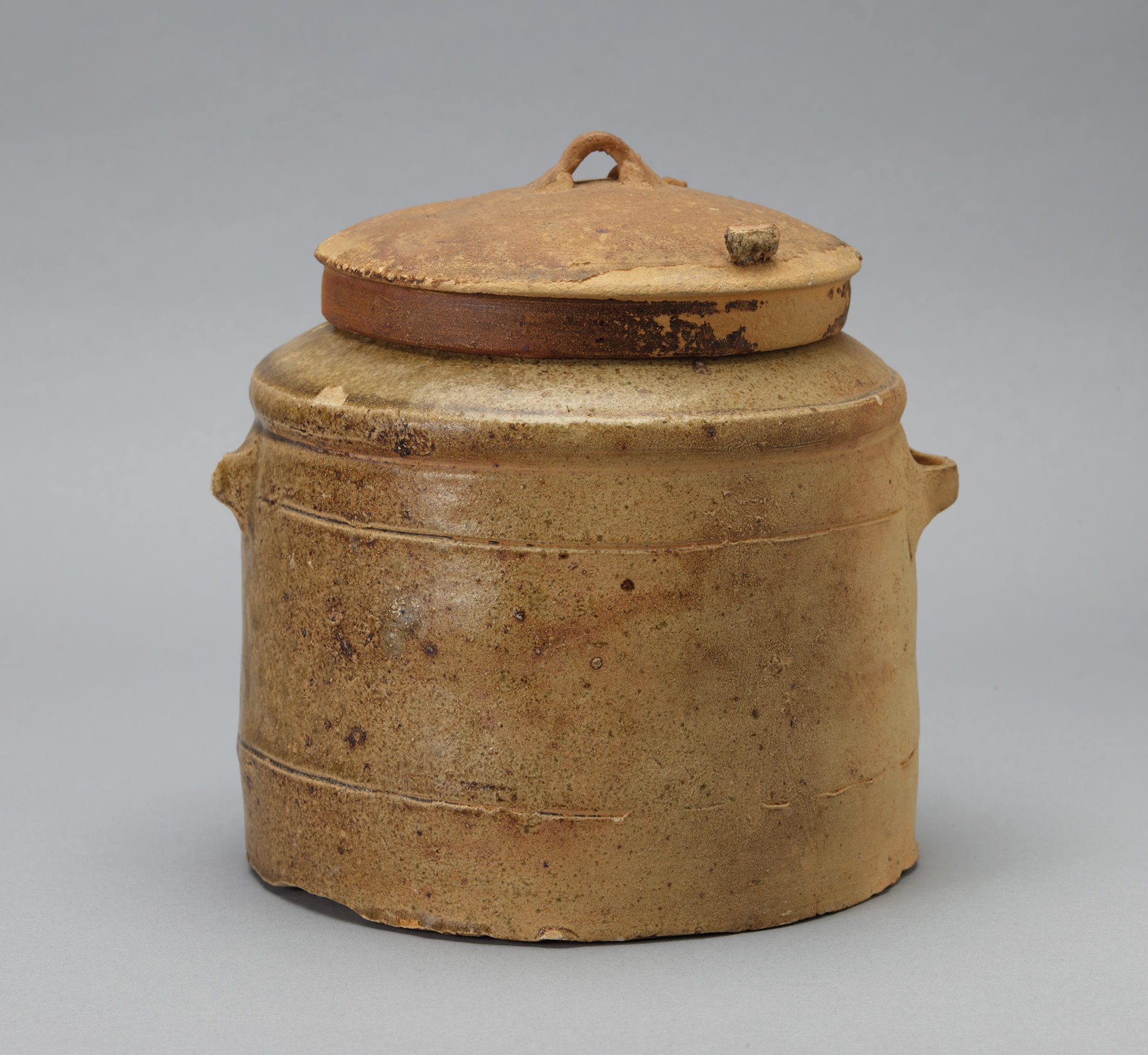 Green-and-yellow glazed pottery jar with straight body