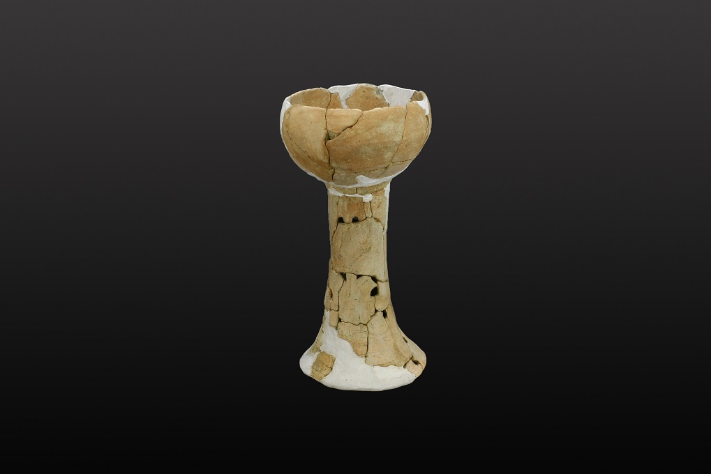 Pottery stem cup with incised pattern and perforations